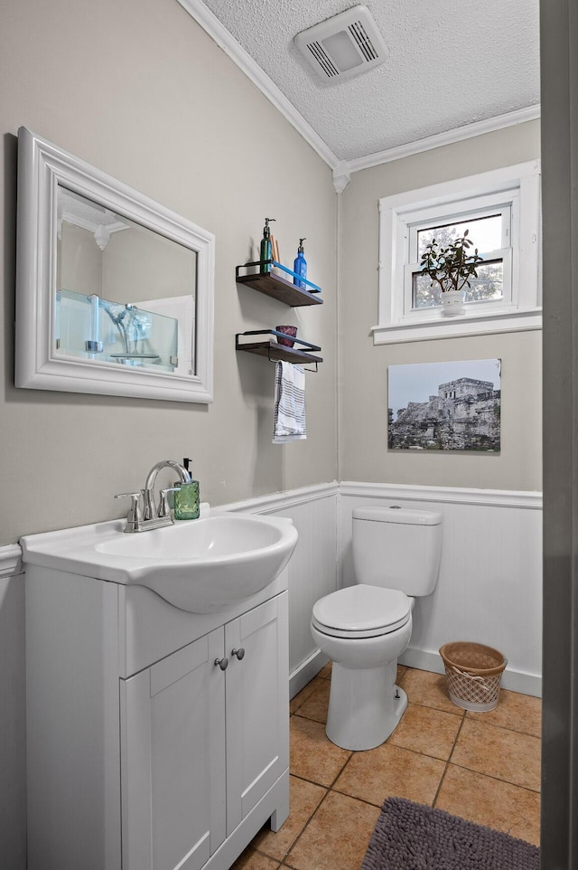 219 Martin Rd, Chattanooga, TN 37415 - bathroom featuring a textured ceiling, crown molding, vanity, toilet, and tile patterned floors
