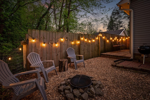 219 Martin Rd, Chattanooga, TN 37415 - patio terrace at dusk with an outdoor fire pit, a deck, and grilling area