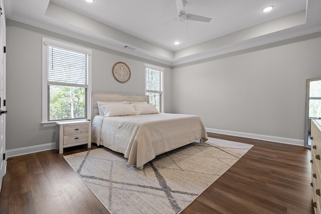 bedroom featuring visible vents, recessed lighting, dark wood finished floors, a raised ceiling, and baseboards