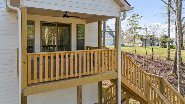 deck with a ceiling fan, stairs, and a residential view