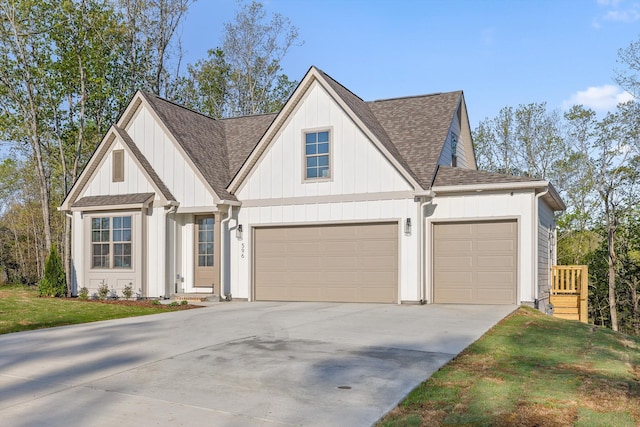 modern inspired farmhouse featuring board and batten siding, a garage, a shingled roof, concrete driveway, and a front yard