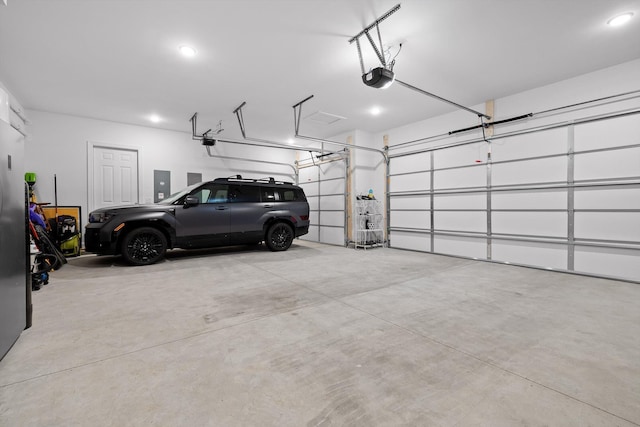 garage featuring recessed lighting and a garage door opener