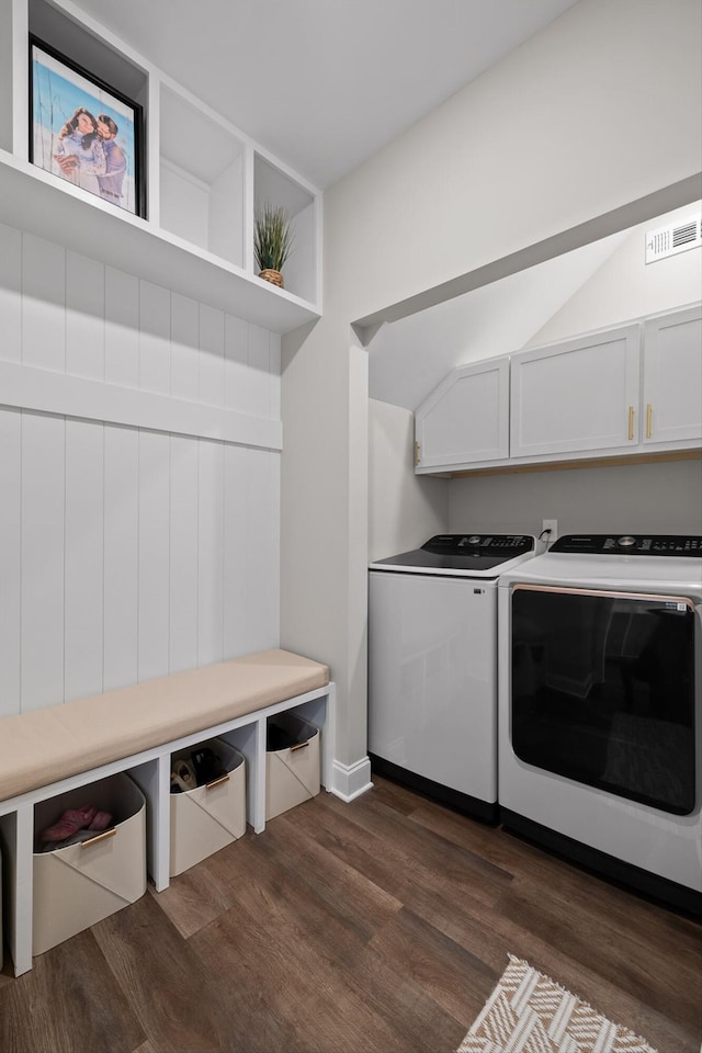 washroom featuring cabinet space, independent washer and dryer, visible vents, and dark wood-style floors