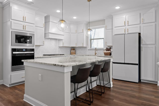 kitchen featuring premium range hood, freestanding refrigerator, white cabinetry, black microwave, and wall oven