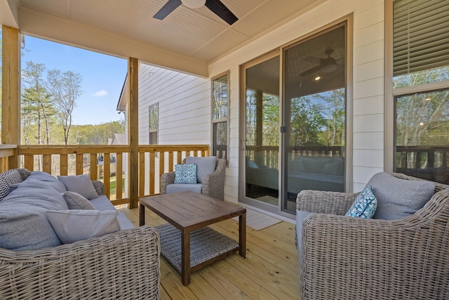 sunroom / solarium featuring a water view, a ceiling fan, and an outdoor living space