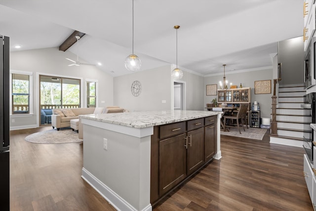 kitchen with light stone countertops, a center island, dark brown cabinets, dark wood-style flooring, and vaulted ceiling with beams