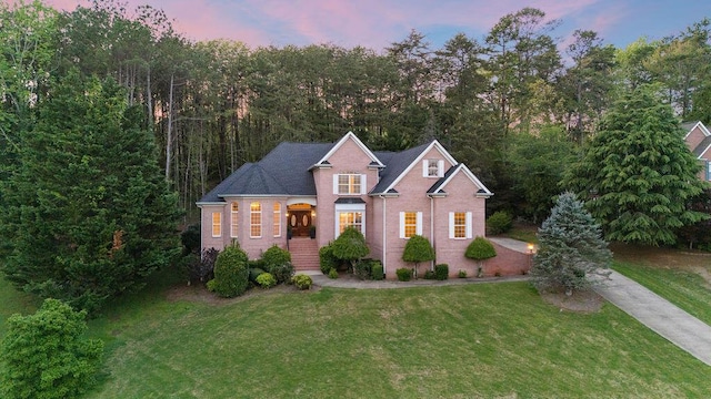 7111 River Run Dr, Chattanooga, TN 37416 - view of front facade with concrete driveway, brick siding, and a front lawn
