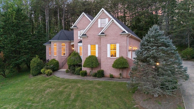 7111 River Run Dr, Chattanooga, TN 37416 - traditional-style house with a front yard and brick siding