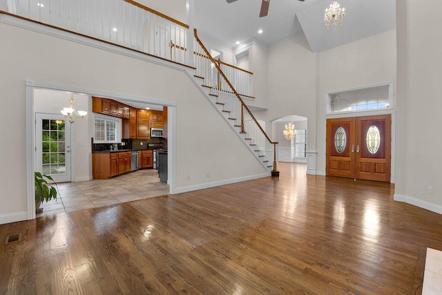 7111 River Run Dr, Chattanooga, TN 37416 - entryway featuring baseboards, light wood-style flooring, stairs, visible vents, and ceiling fan with notable chandelier