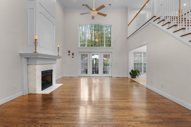 7111 River Run Dr, Chattanooga, TN 37416 - unfurnished living room with baseboards, a tiled fireplace, ornamental molding, a ceiling fan, and wood finished floors