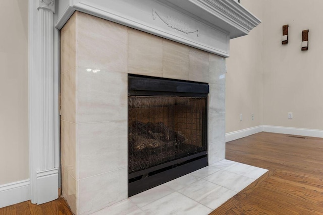 7111 River Run Dr, Chattanooga, TN 37416 - room details with baseboards, wood finished floors, and a tile fireplace