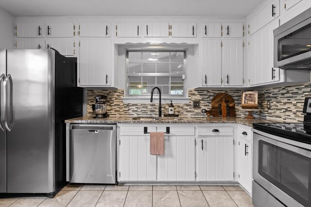 1905 Bella Vista Dr, Chattanooga, TN 37421 - kitchen featuring appliances with stainless steel finishes, a sink, decorative backsplash, and white cabinetry