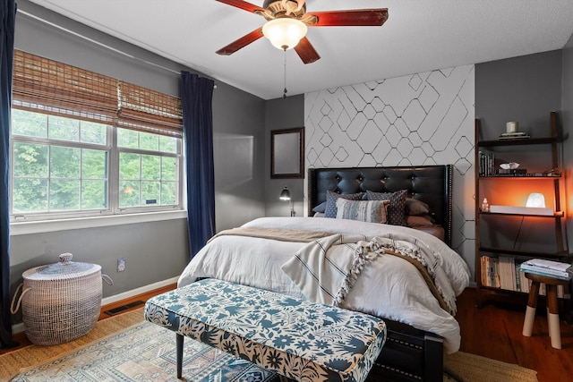 1905 Bella Vista Dr, Chattanooga, TN 37421 - bedroom featuring wood finished floors, an accent wall, baseboards, and a ceiling fan