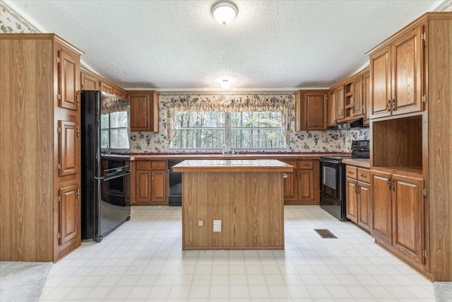 255 Bible Gulf Rd, Menlo, GA 30731 - kitchen featuring plenty of natural light, extractor fan, a textured ceiling, and black appliances