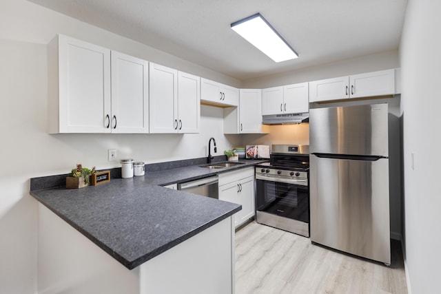 900 Mountain Creek Rd # R311, Chattanooga, TN 37405 - kitchen with stainless steel appliances, under cabinet range hood, a peninsula, and white cabinetry