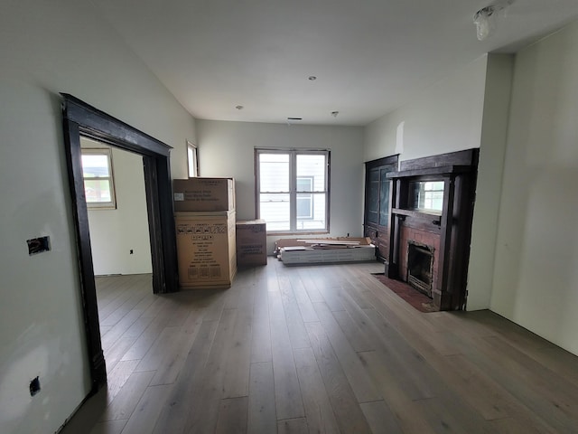 unfurnished living room featuring wood finished floors and a fireplace