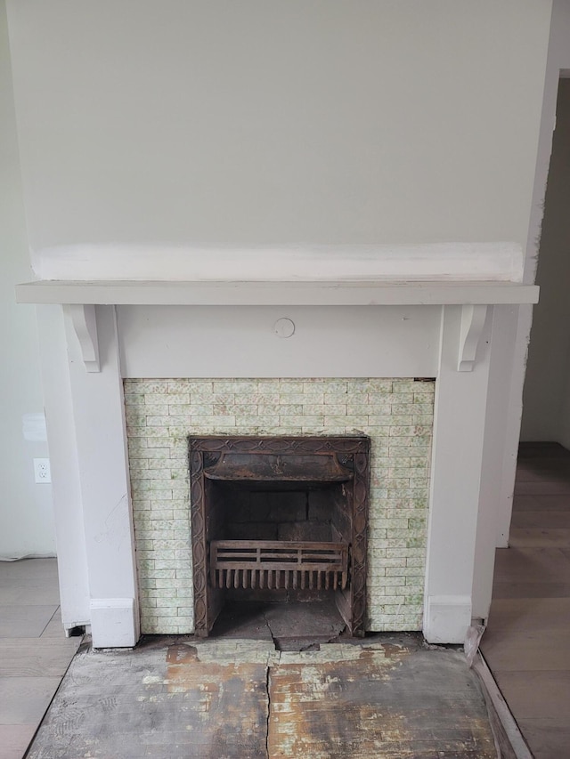 interior details featuring wood finished floors and a fireplace