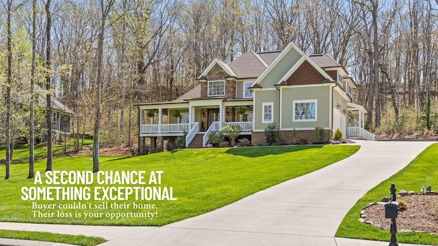 craftsman-style home featuring driveway, a porch, a front yard, brick siding, and stone siding