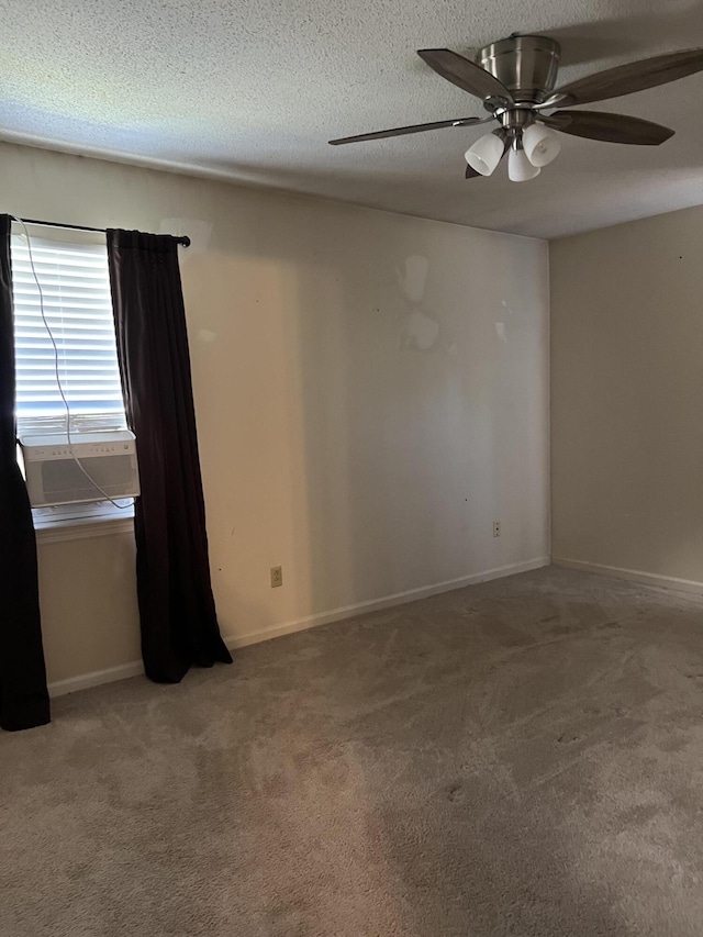 empty room with a textured ceiling, baseboards, a ceiling fan, and carpet floors