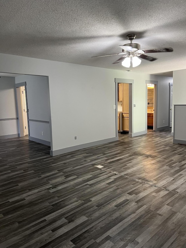 9121 Potomac Dr, Chattanooga, TN 37421 - unfurnished living room featuring dark wood-type flooring, baseboards, ceiling fan, and a textured ceiling