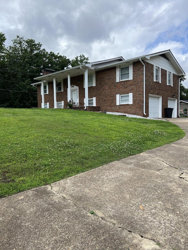 9121 Potomac Dr, Chattanooga, TN 37421 - raised ranch with brick siding, a front yard, and concrete driveway