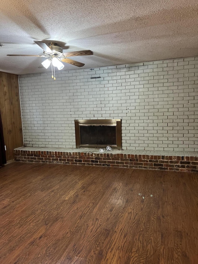 9121 Potomac Dr, Chattanooga, TN 37421 - unfurnished living room featuring wood finished floors, a brick fireplace, a ceiling fan, a textured ceiling, and baseboards