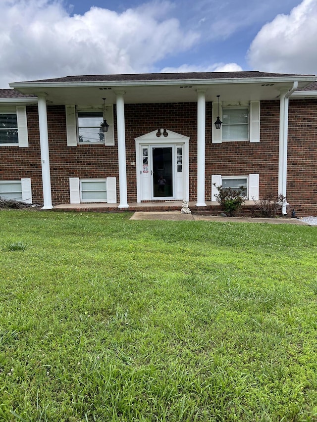 9121 Potomac Dr, Chattanooga, TN 37421 - view of front of property with brick siding, a front lawn, and covered porch