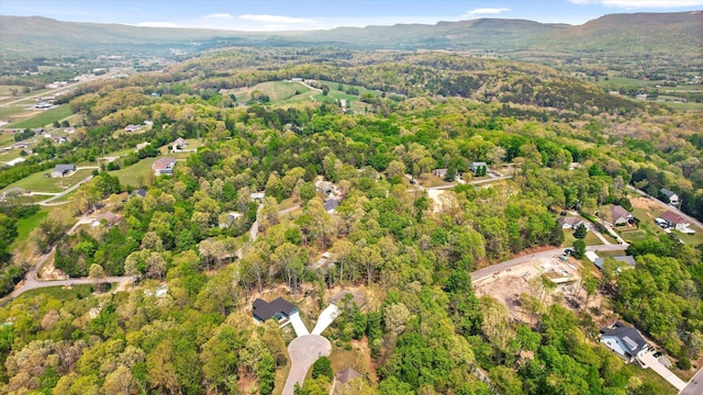 aerial view with a wooded view and a mountain view