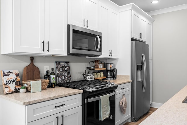 kitchen with recessed lighting, stainless steel appliances, baseboards, light wood-style flooring, and white cabinetry