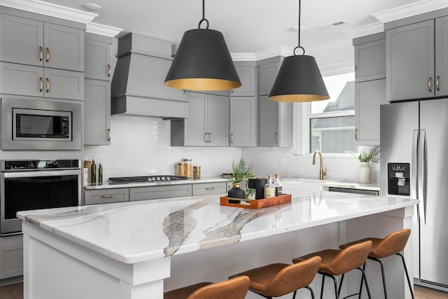 92 Lemonade St, Chattanooga, TN 37421 - kitchen featuring stainless steel appliances, gray cabinetry, custom exhaust hood, a kitchen island, and ornamental molding