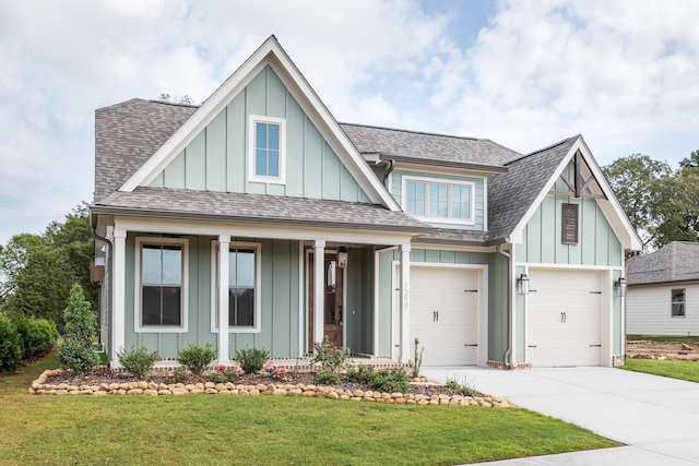 92 Lemonade St, Chattanooga, TN 37421 - view of front of home with board and batten siding, concrete driveway, a front yard, and a shingled roof