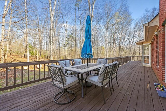 wooden terrace with outdoor dining space
