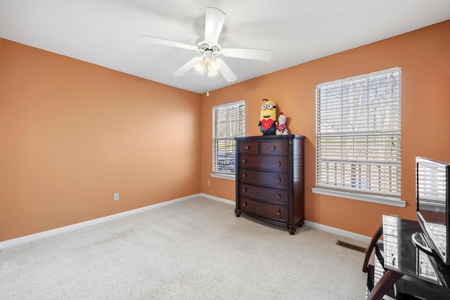 carpeted bedroom with baseboards and a ceiling fan