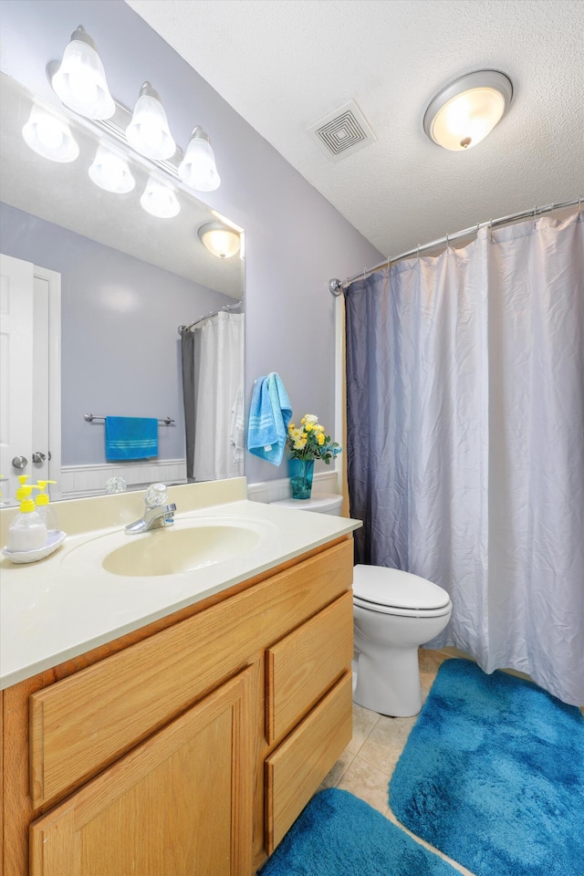 full bathroom with toilet, vanity, tile patterned flooring, and visible vents