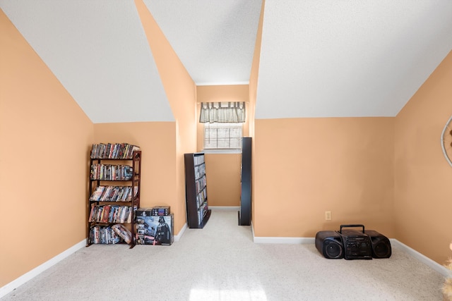 bonus room with carpet floors, baseboards, vaulted ceiling, and a textured ceiling