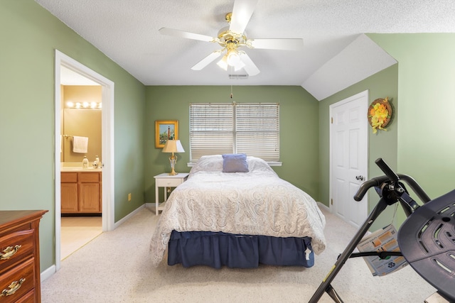 bedroom with baseboards, a sink, a ceiling fan, a textured ceiling, and connected bathroom
