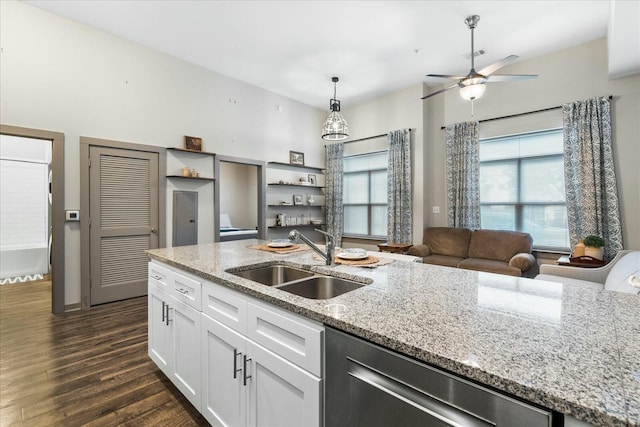 kitchen featuring ceiling fan, stainless steel dishwasher, dark wood finished floors, white cabinets, and a sink