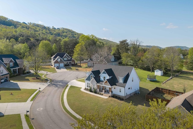 drone / aerial view with a view of trees and a residential view
