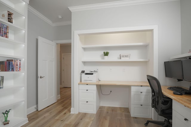 office space featuring light wood-style flooring, baseboards, and ornamental molding