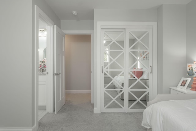carpeted bedroom featuring baseboards