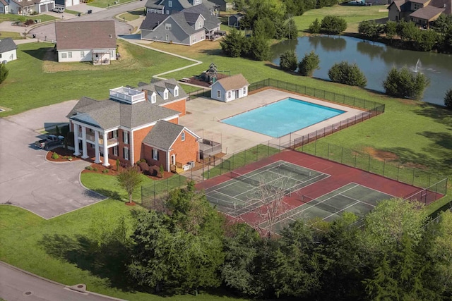 drone / aerial view with a water view and a residential view