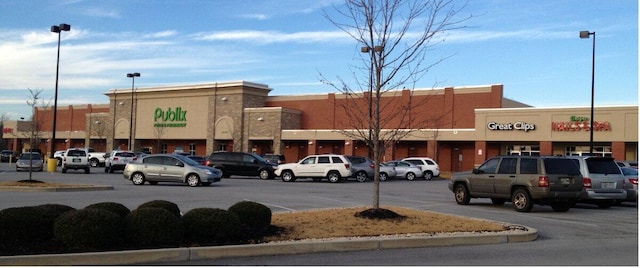 view of building exterior with uncovered parking