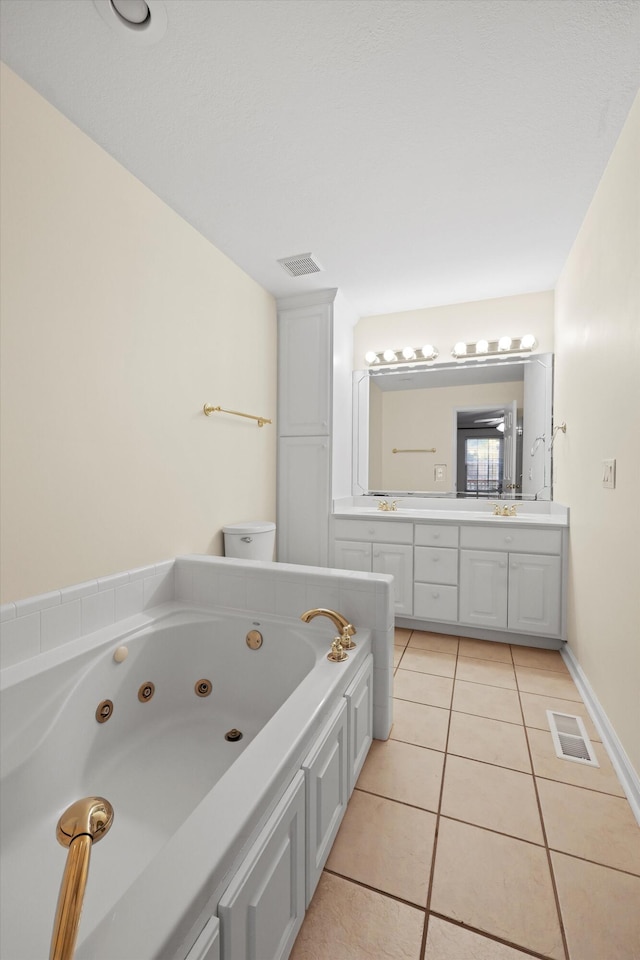 bathroom featuring visible vents, tile patterned floors, double vanity, and a whirlpool tub