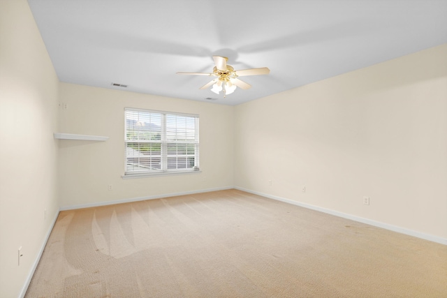 empty room with ceiling fan, baseboards, carpet, and visible vents