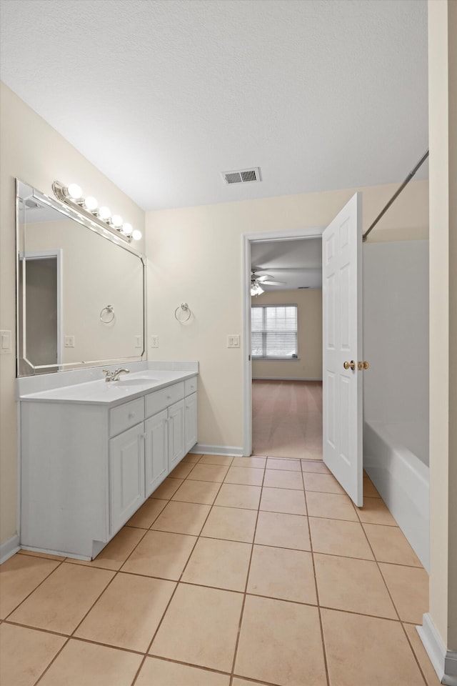 full bath featuring bathtub / shower combination, vanity, visible vents, tile patterned floors, and baseboards
