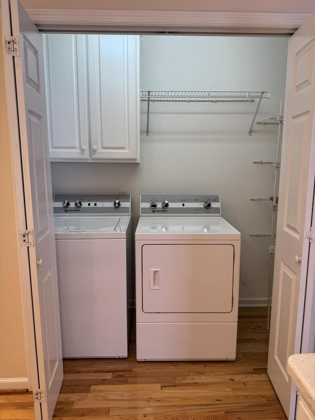 4521 Solomon Seal Trl, Chattanooga, TN 37415 - laundry area with cabinet space, independent washer and dryer, and light wood-type flooring