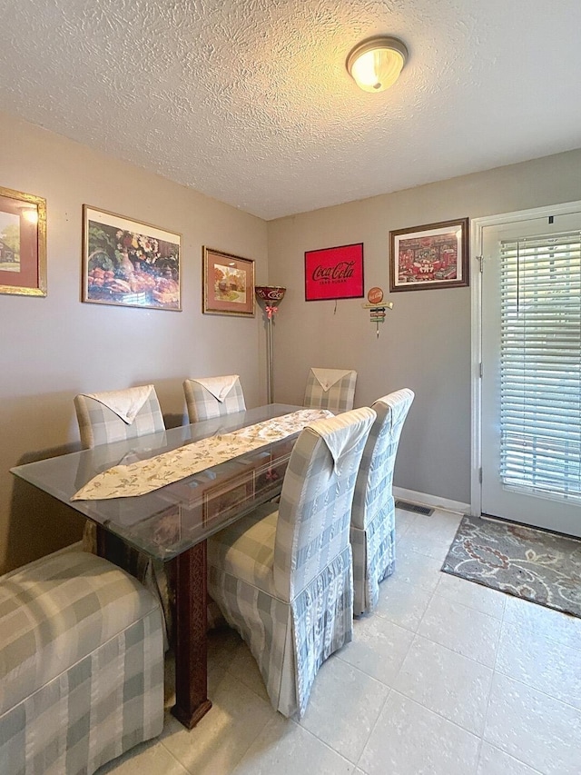 dining area with a textured ceiling