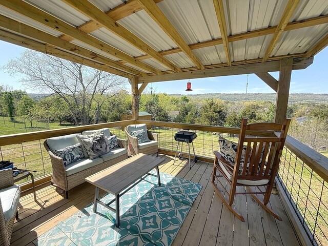 deck with a view of trees and an outdoor hangout area