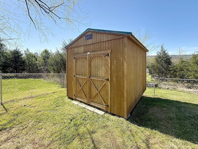 view of shed featuring fence
