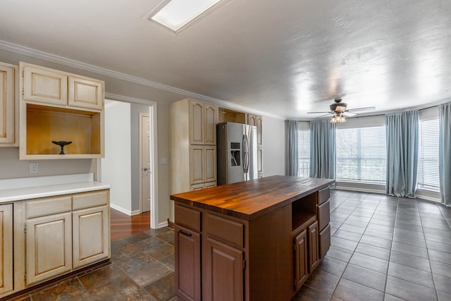 kitchen featuring stainless steel fridge with ice dispenser, baseboards, ceiling fan, crown molding, and butcher block countertops
